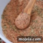 Ultimate Meatloaf Blend 6 Homemade meatloaf seasoning in a bowl with a wooden spoon