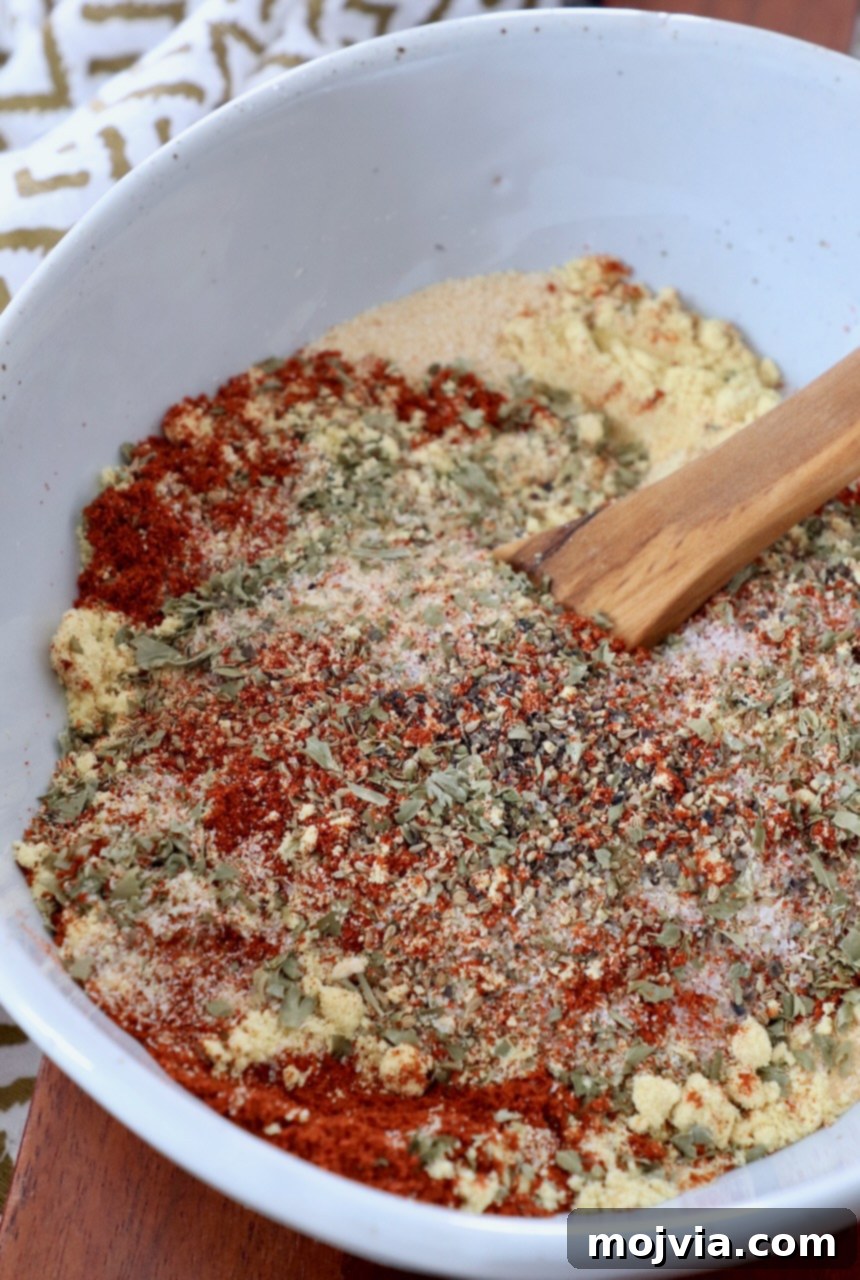 Ultimate Meatloaf Blend 4 Mixed herbs and spices in a bowl with a wooden spoon