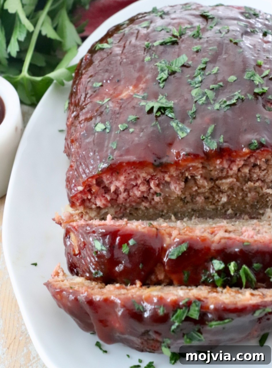 Pitmaster's Smoked Meatloaf 11 sliced, smoked meatloaf on plate with a clear view of the smoke ring