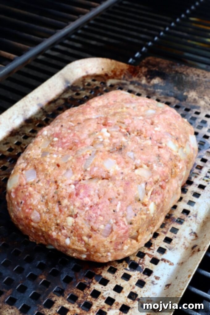 Pitmaster's Smoked Meatloaf 6 uncooked meatloaf formed on a grill pan, ready for the smoker