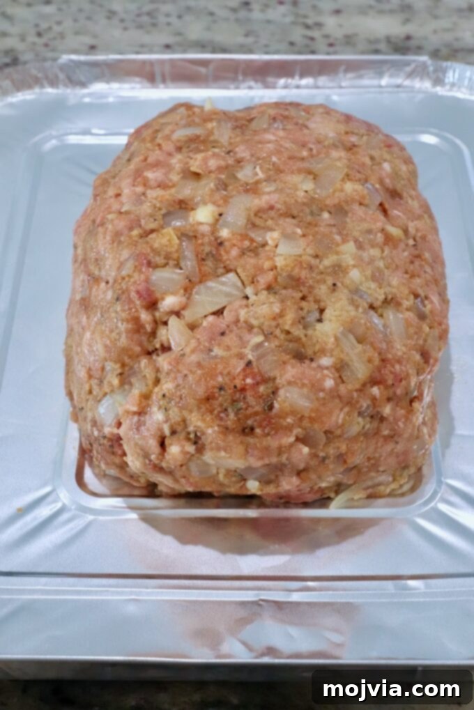 Pitmaster's Smoked Meatloaf 7 uncooked meatloaf resting on a doubled piece of aluminum foil