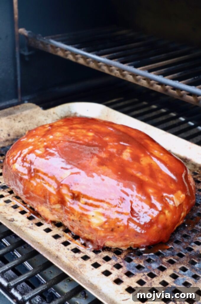 Pitmaster's Smoked Meatloaf 9 bbq glazed meatloaf cooking in a smoker