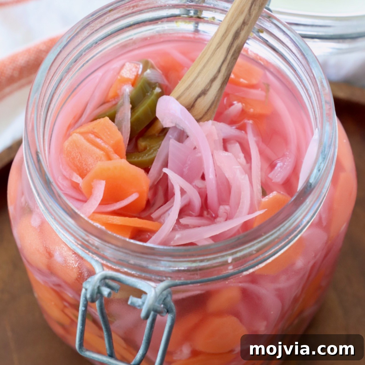 pickled onions, carrots and jalapenos in large glass mason jar