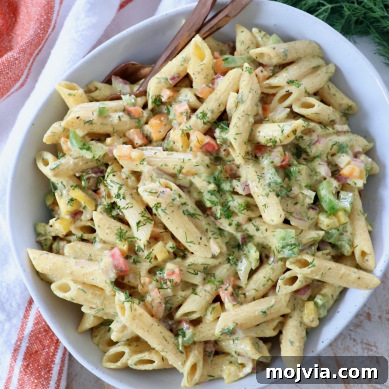 prepared pasta salad in bowl with forks