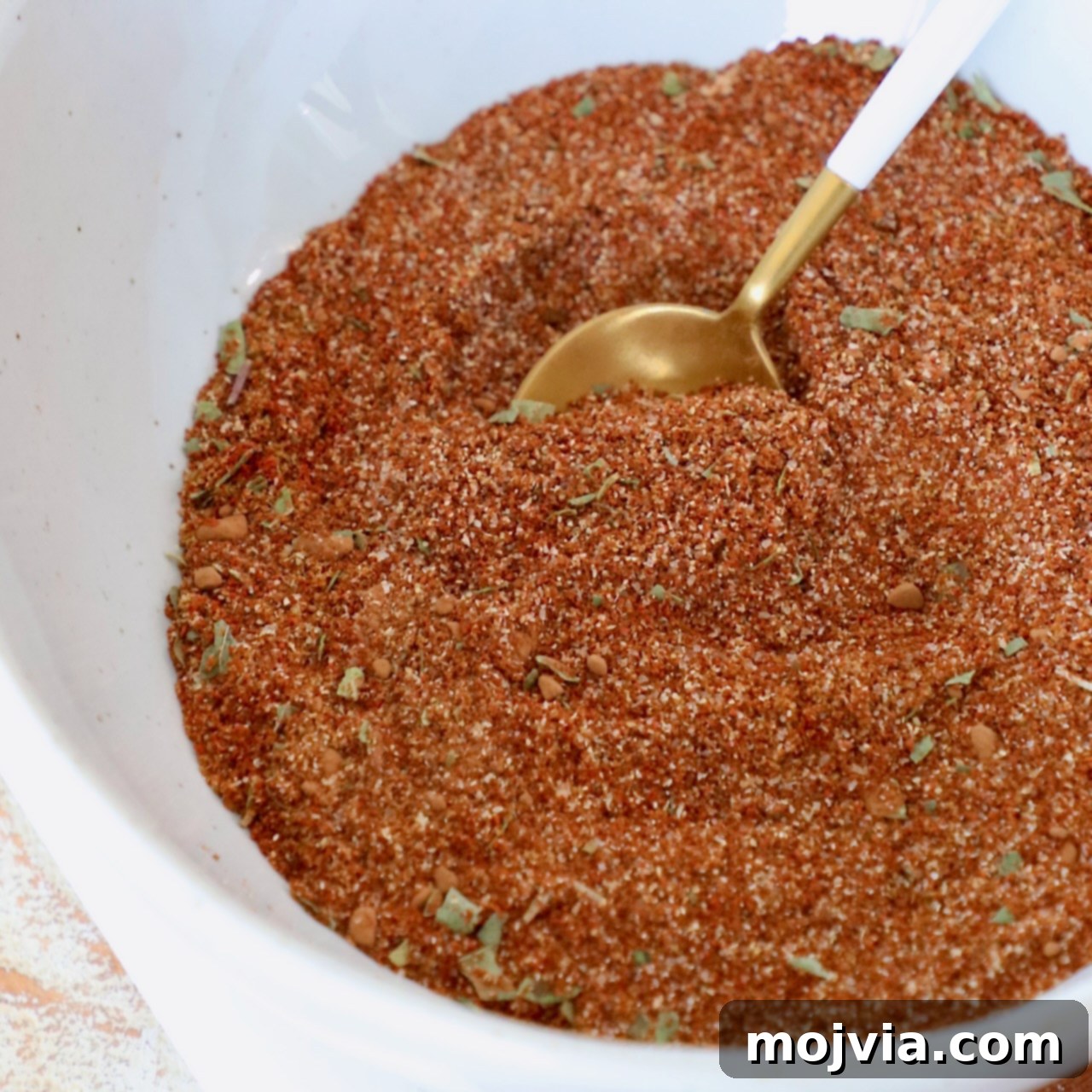 enchilada seasoning in bowl with spoon