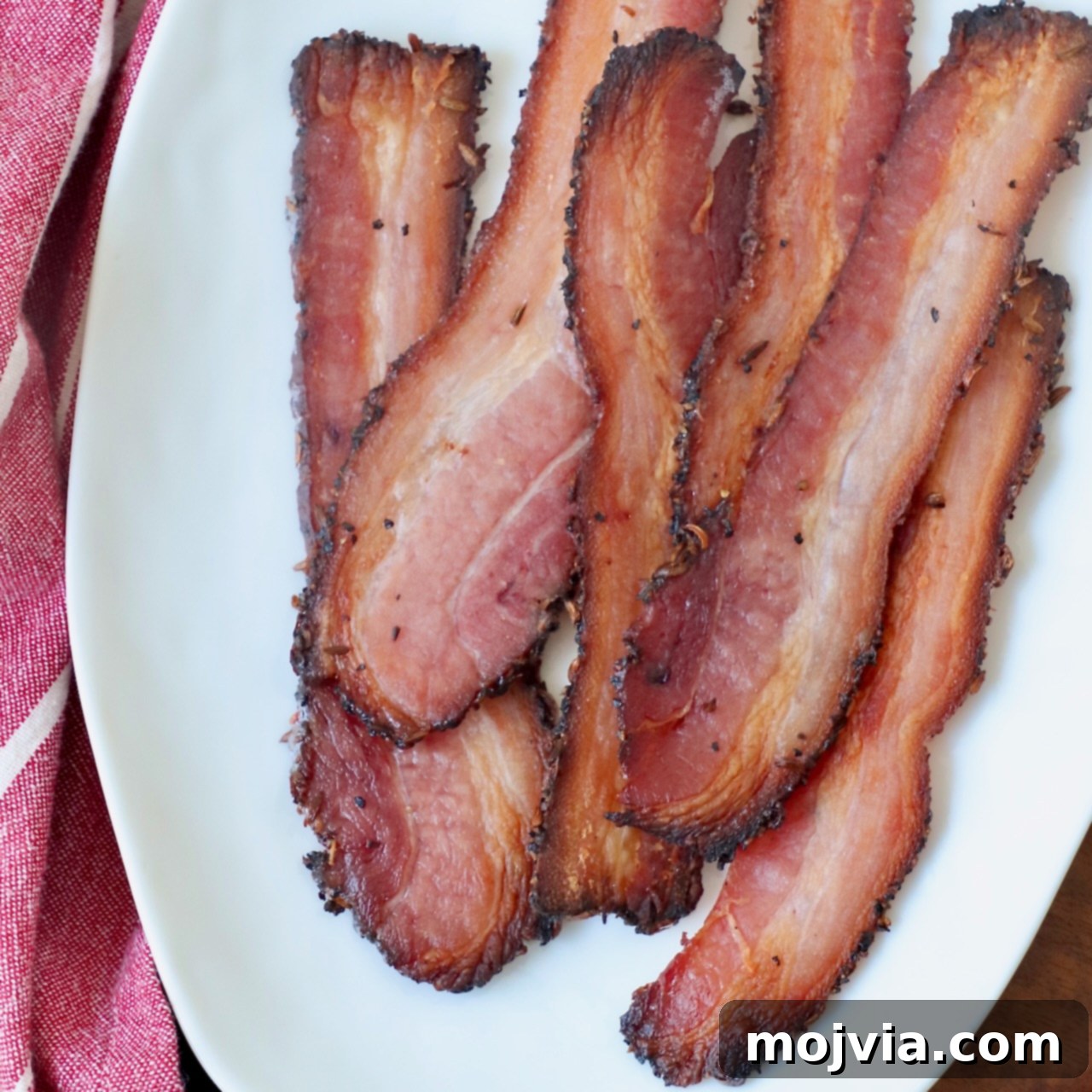 cooked slices of bacon on white plate