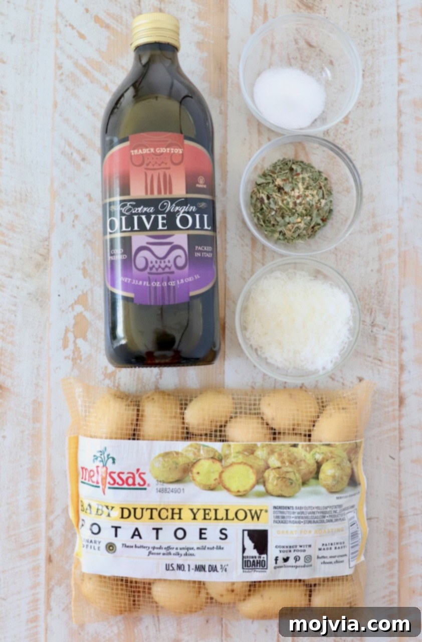 Roasted Small Potatoes 3 Ingredients for crispy roasted baby potatoes laid out on a white wooden board, including baby potatoes, olive oil, Italian seasoning, salt, and Parmesan cheese.