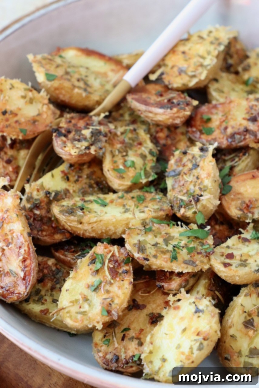 Roasted Small Potatoes 9 A bowl of perfectly golden and crispy roasted baby potatoes, garnished with fresh herbs, ready to be enjoyed.
