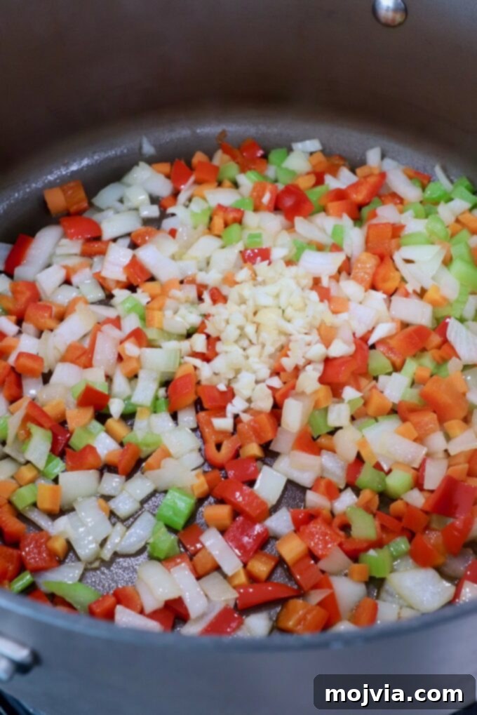 Zesty Southwest Black Bean Soup 4 diced onions, carrots, red bell peppers, garlic and celery in large pot on stove