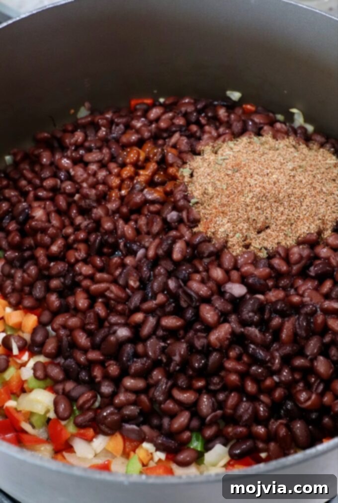 Zesty Southwest Black Bean Soup 5 black beans in pot on the stove with diced veggies and spices
