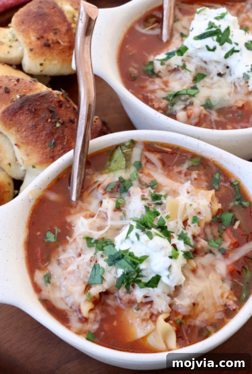 Hearty Lasagna Soup 2 lasagna soup in bowls with spoons