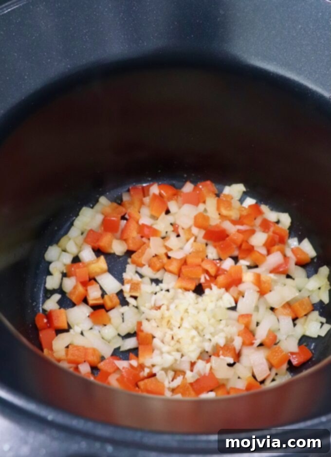 Hearty Lasagna Soup 4 diced bell pepper, onion and garlic in pot on the stove