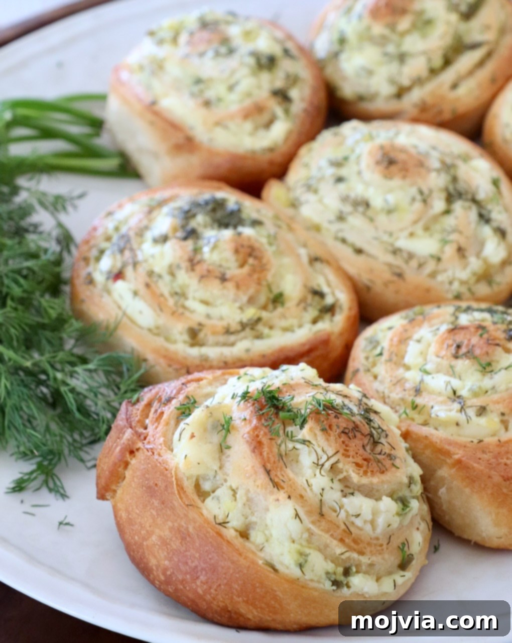 creamy pickle crescent rolls on plate with fresh dill