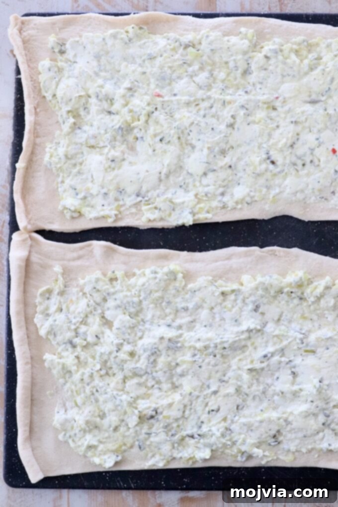 cream cheese and relish spread on crescent roll dough