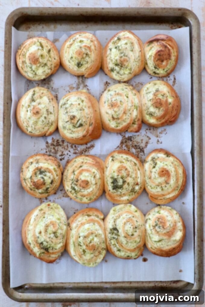 baked creamy pickle crescent rolls on parchment-lined baking sheet