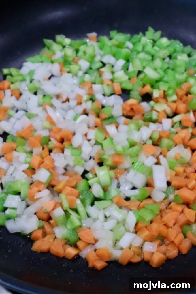 Zesty Buffalo Chicken Poppers 4 Finely diced onions, carrots, and celery cooking in a skillet