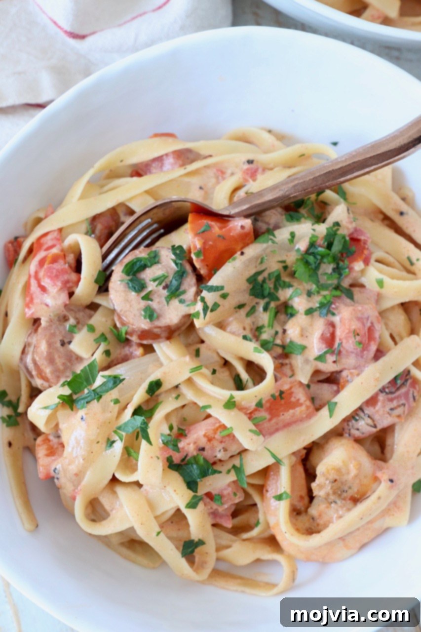 Spicy Cajun Shrimp and Sausage Pasta 4 cooked cajun shrimp pasta with sausage in bowl with spoon