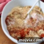 spices mixed with brown sugar in bowl with spoon, a perfect dry rub for ribs
