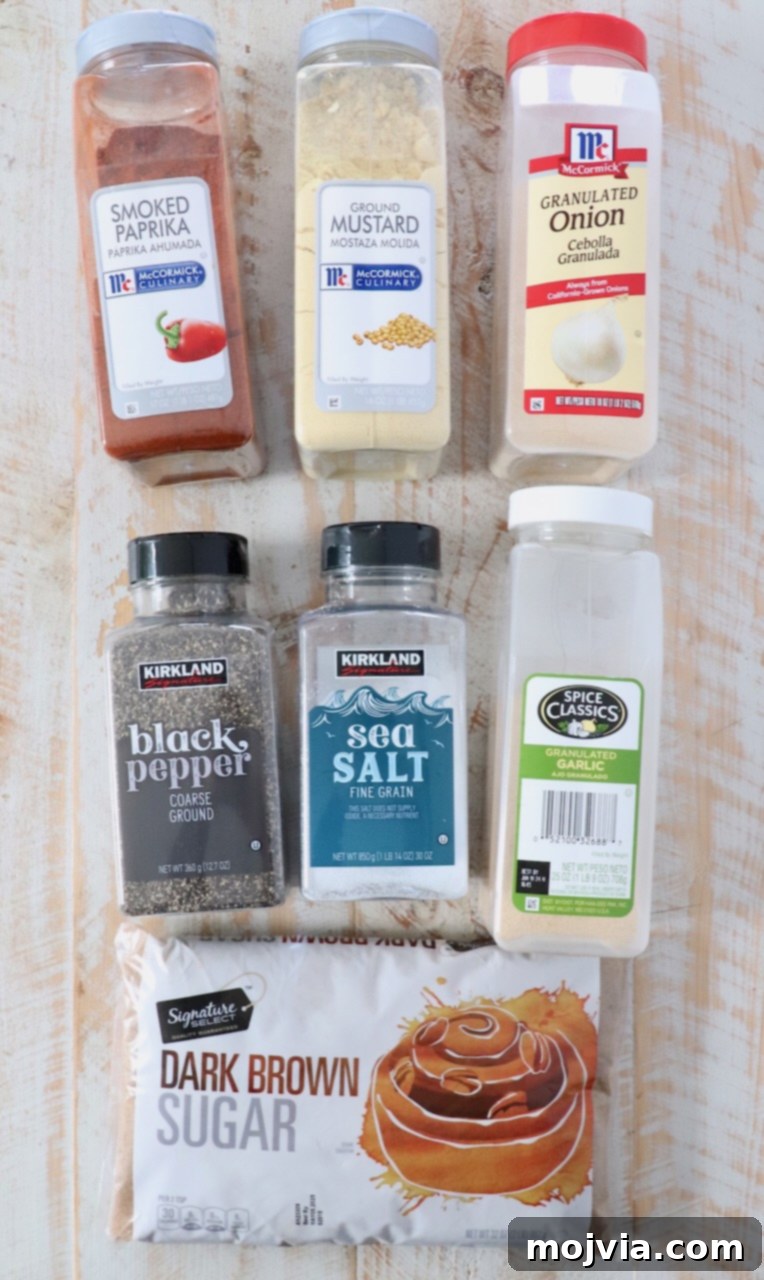 Individual ingredients for dry rib rub laid out on a white wooden board