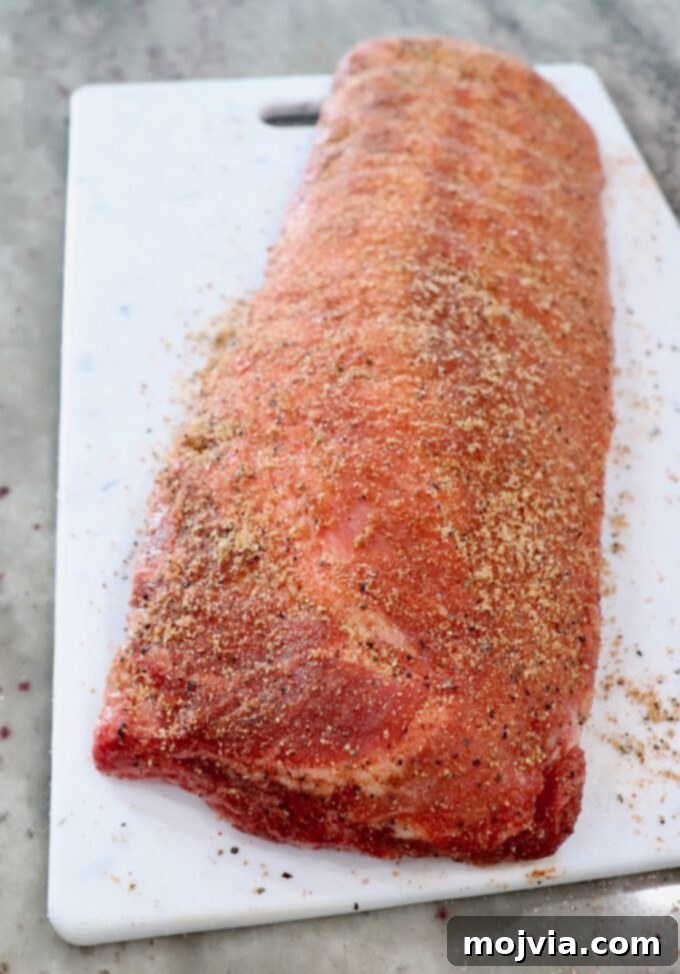 Fall Off The Bone Instant Pot Ribs 4 seasoned rack of baby back ribs on white cutting board