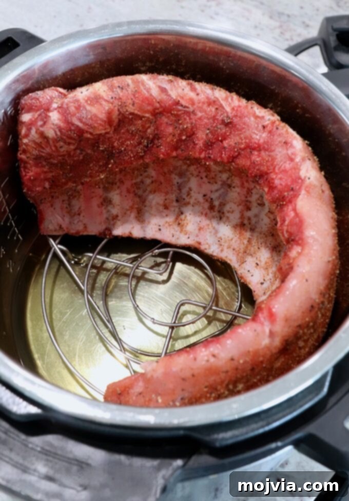 Fall Off The Bone Instant Pot Ribs 5 uncooked rack of baby back ribs in Instant Pot