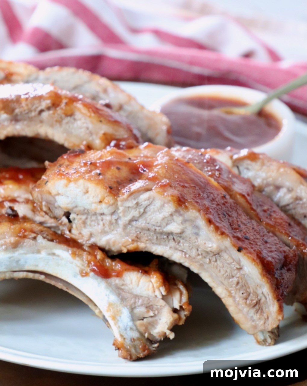 Fall Off The Bone Instant Pot Ribs 8 cooked baby back ribs sliced apart on plate