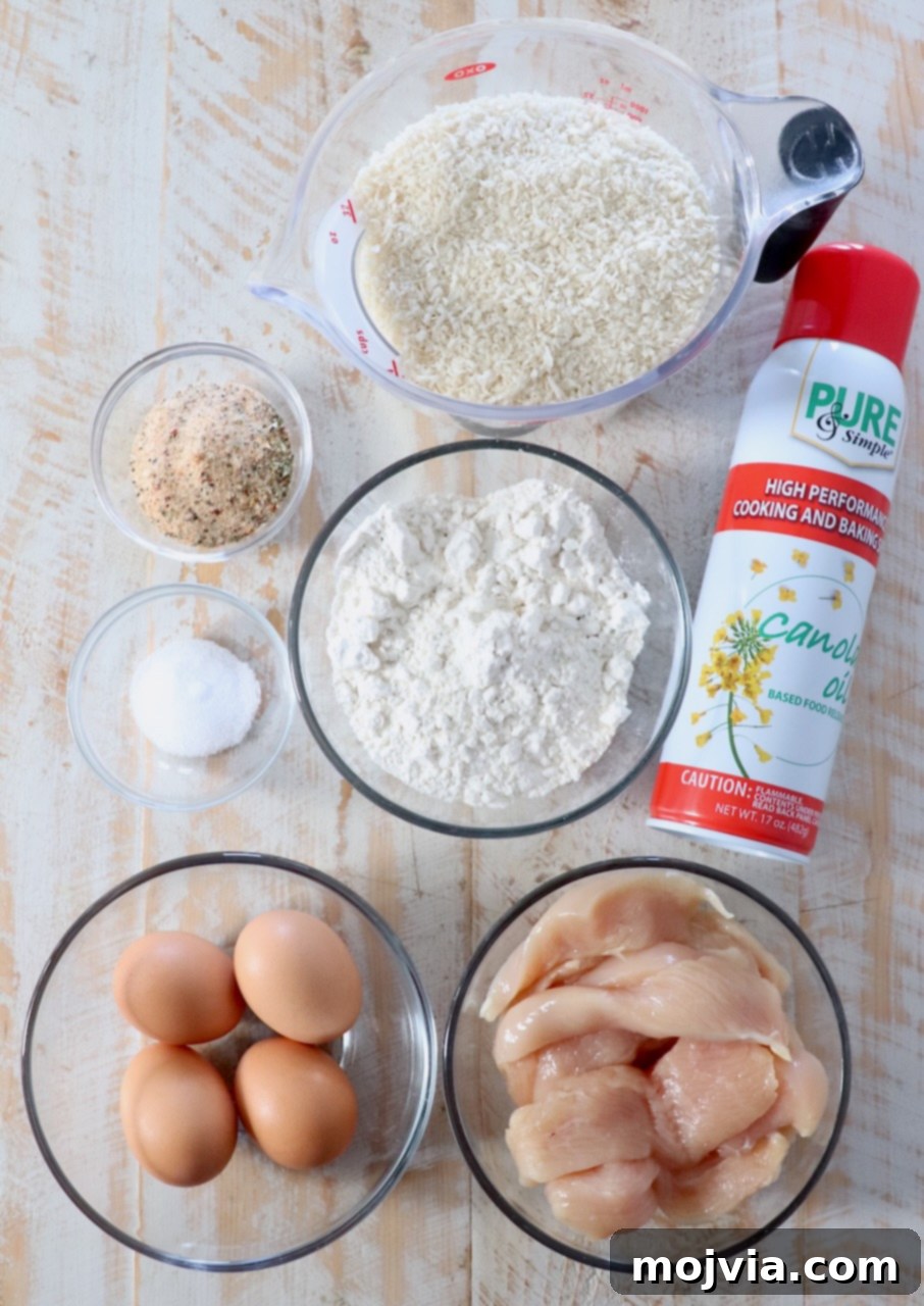Golden Crispy Air Fryer Chicken 3 ingredients for air fryer chicken tenders on white wood board