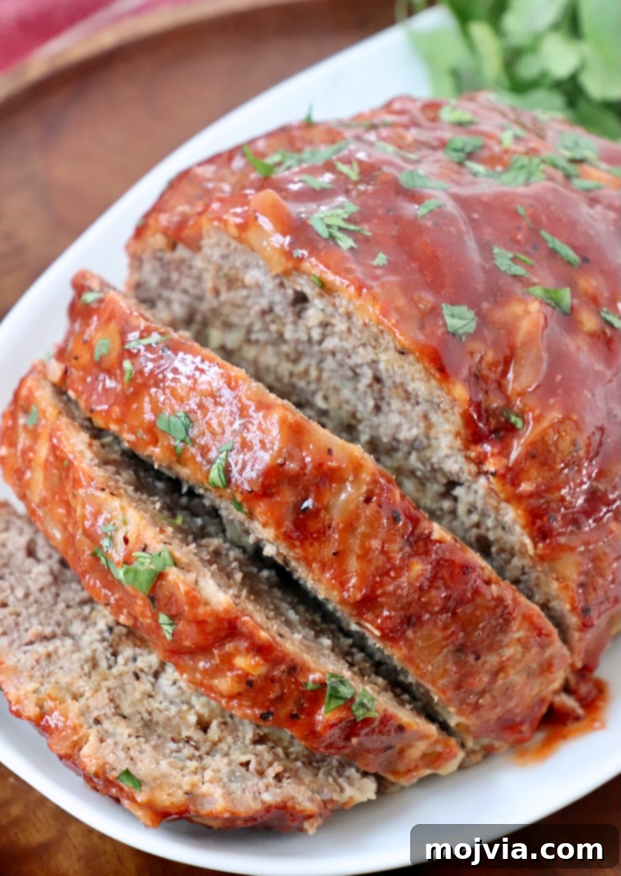 meatloaf sliced on plate with fresh parsley