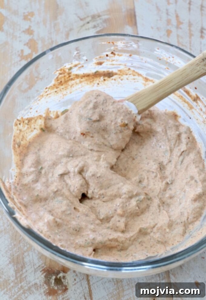The Southwest Salad Dressing already mixed in a bowl, showing its creamy texture and specks of cilantro.
