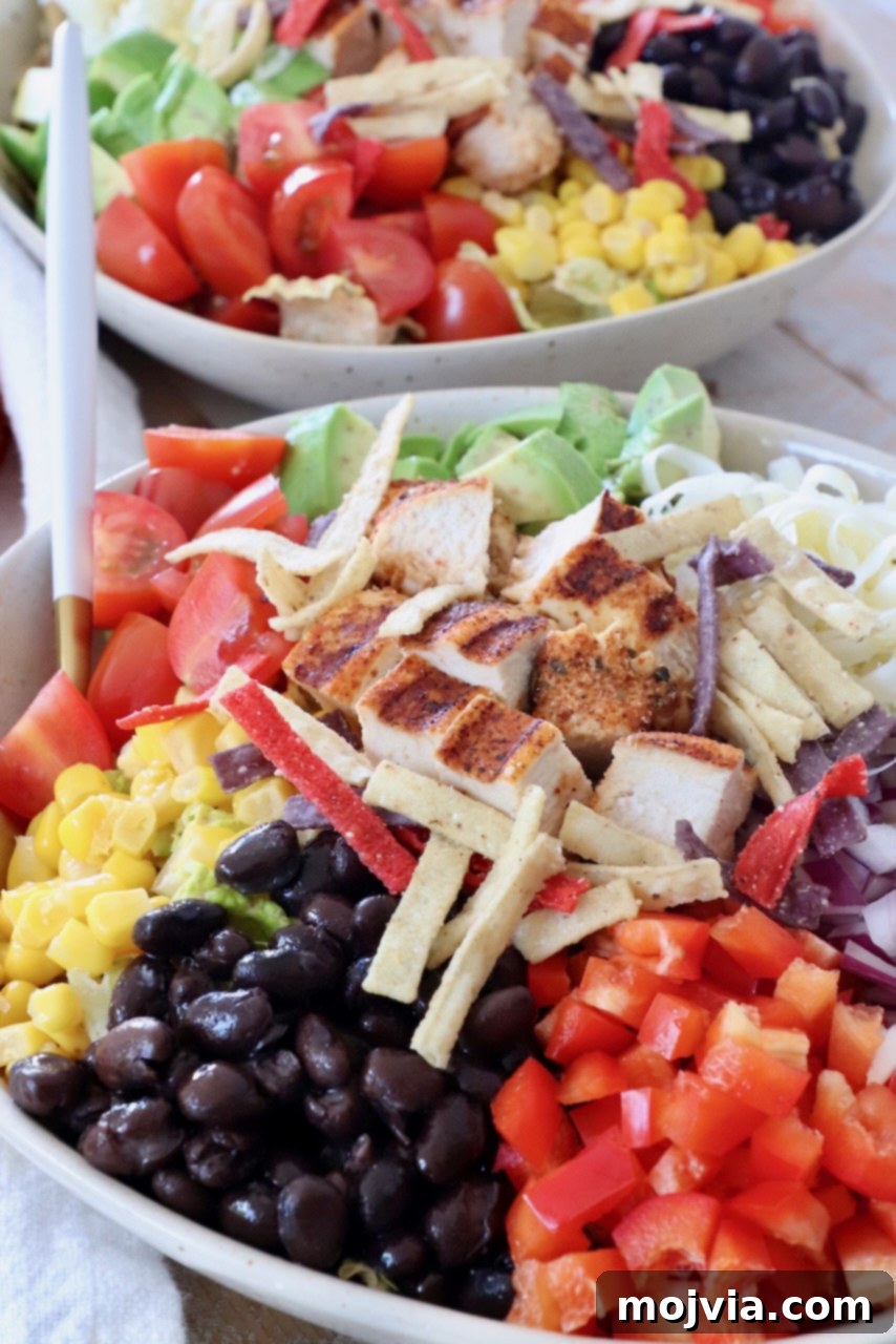 Vibrant Southwest Salad 4 salad in bowl topped with black beans, corn and grilled chicken