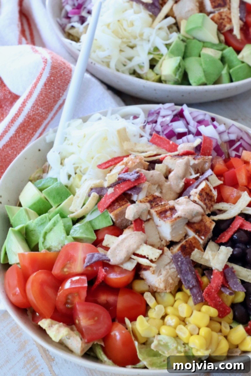 Vibrant Southwest Salad 10 salad in bowl topped with chicken and creamy dressing