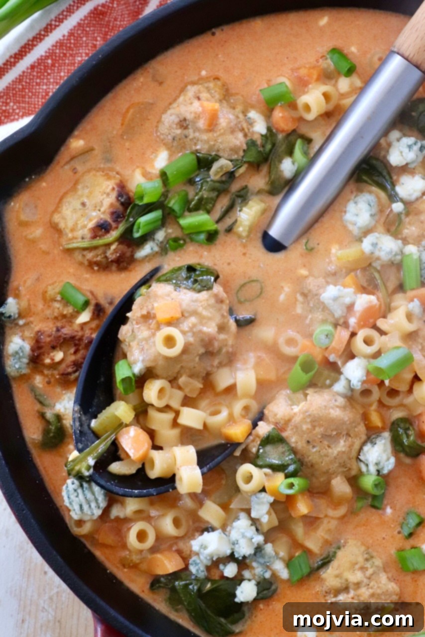 Bold Buffalo Chicken Soup 2 A large skillet filled with creamy buffalo chicken meatball soup, ready to be served with a ladle.