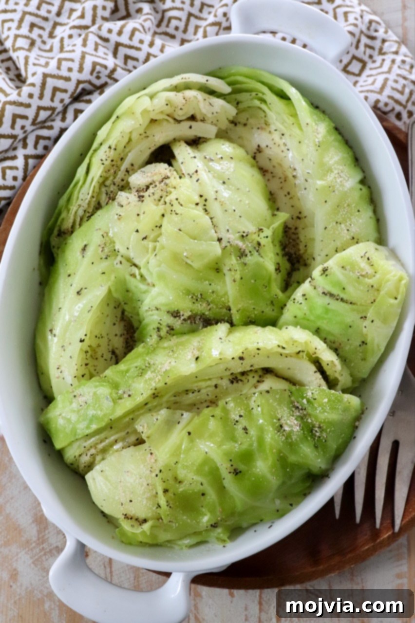 Perfectly steamed cabbage wedges arranged beautifully in a serving dish, highlighting their vibrant green color and tender texture, ready for the table.