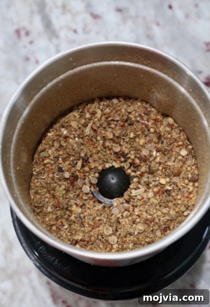 Signature Corned Beef Spice Blend 6 Close-up view of the corned beef seasoning blend after being coarsely ground in a spice grinder, showcasing its texture and rich color, ready for storage and use.