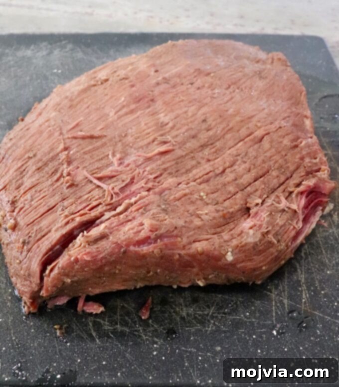 cooked brisket on cutting board