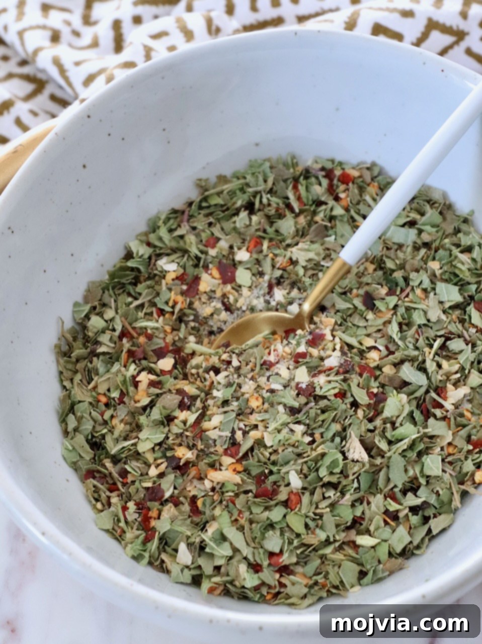 Zesty Italian Vinaigrette Blend 2 herbs and spices combined in bowl with small spoon