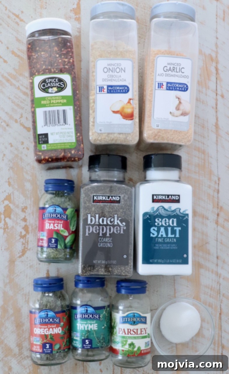 Zesty Italian Vinaigrette Blend 3 herbs and spices in plastic containers on white wood board
