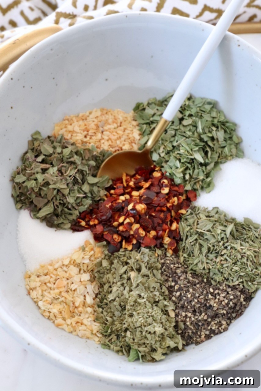 Zesty Italian Vinaigrette Blend 5 herbs and spices separated in bowl with spoon