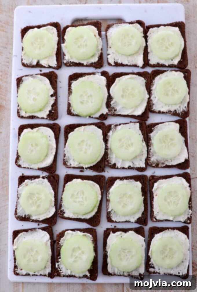 Delicate Cucumber Delights 6 Thinly sliced cucumbers arranged on top of cream cheese spread on cocktail rye bread.