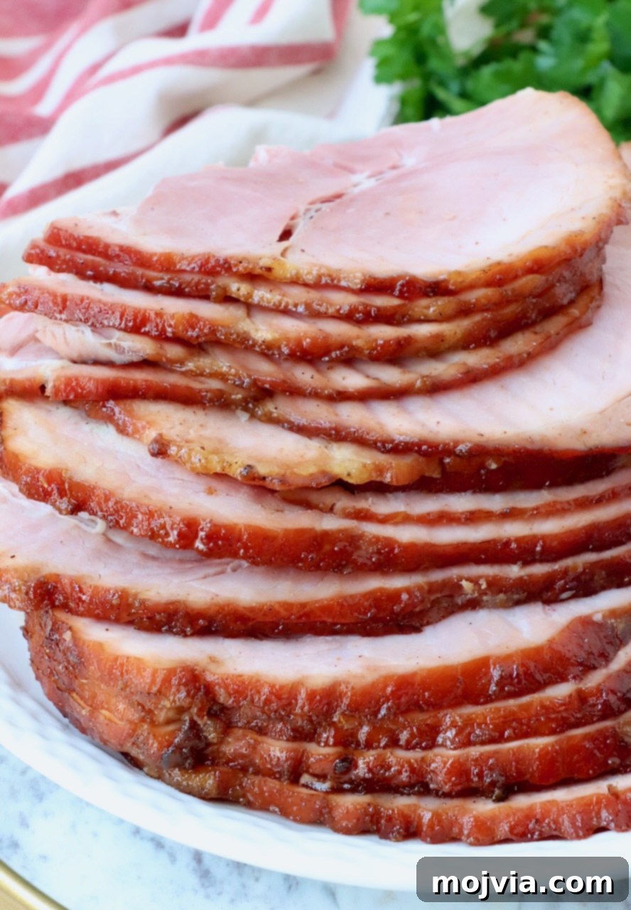 Golden Honey Glazed Ham Feast 2 Perfectly sliced honey baked ham, ready to serve on a festive plate.
