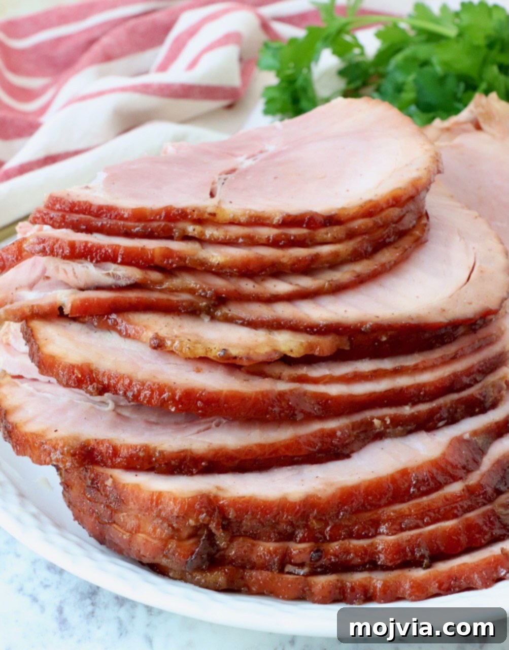Golden Honey Glazed Ham Feast 11 Close-up of deliciously sliced ham, ready to be enjoyed.
