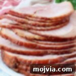 slices of ham stacked up on plate