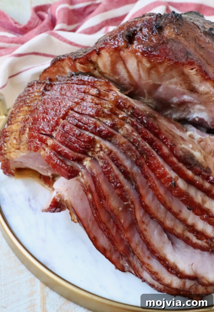 Golden Honey Glazed Ham Feast 10 Sliced honey baked ham arranged beautifully on a marble serving tray.