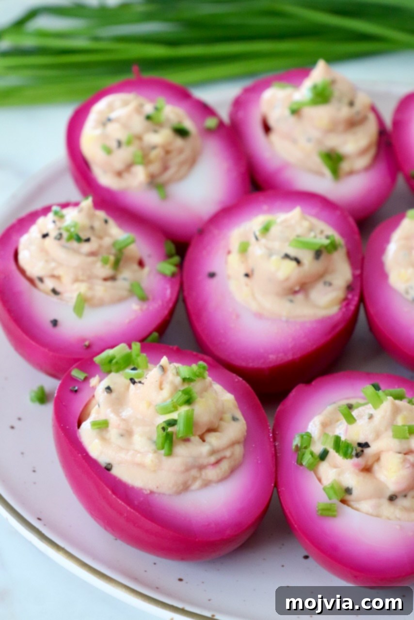 A beautifully composed plate of beet pickled deviled eggs, ready to be served.
