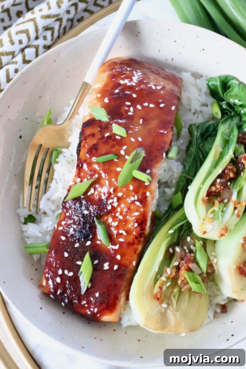 Golden Glazed Miso Salmon 2 piece of cooked miso glazed salmon in bowl with cooked rice and baby bok choy