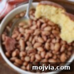 The Humble Pinto: A Culinary Staple 10 cooked pinto beans in bowl with spoon and cornbread