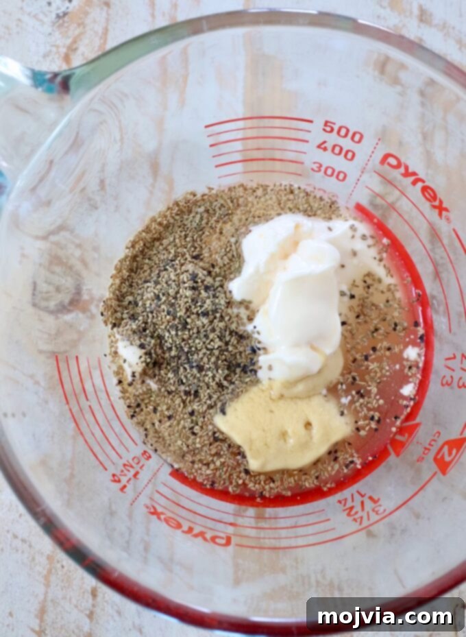 Zesty Coleslaw Dressing 4 Coleslaw dressing ingredients being measured into a glass cup