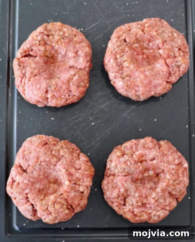 raw burger patties on cutting board
