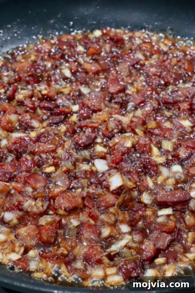 Sweet & Savory Bacon Preserve 12 The finished bacon jam in a skillet, thick and jammy, ready to be cooled and transferred.