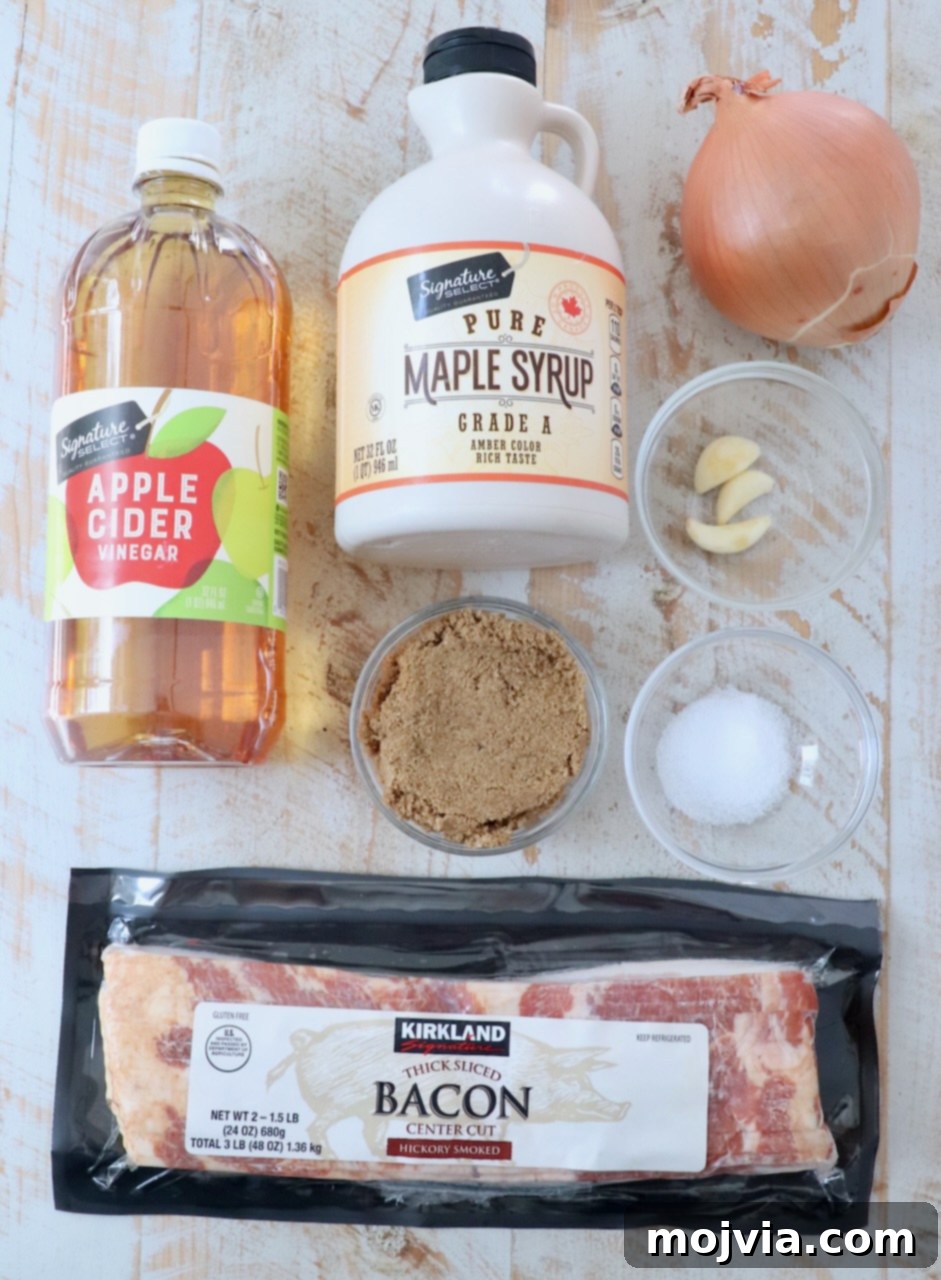 Sweet & Savory Bacon Preserve 3 All the fresh ingredients laid out on a white wooden board for making homemade bacon jam, including diced bacon, onions, garlic, brown sugar, and maple syrup.
